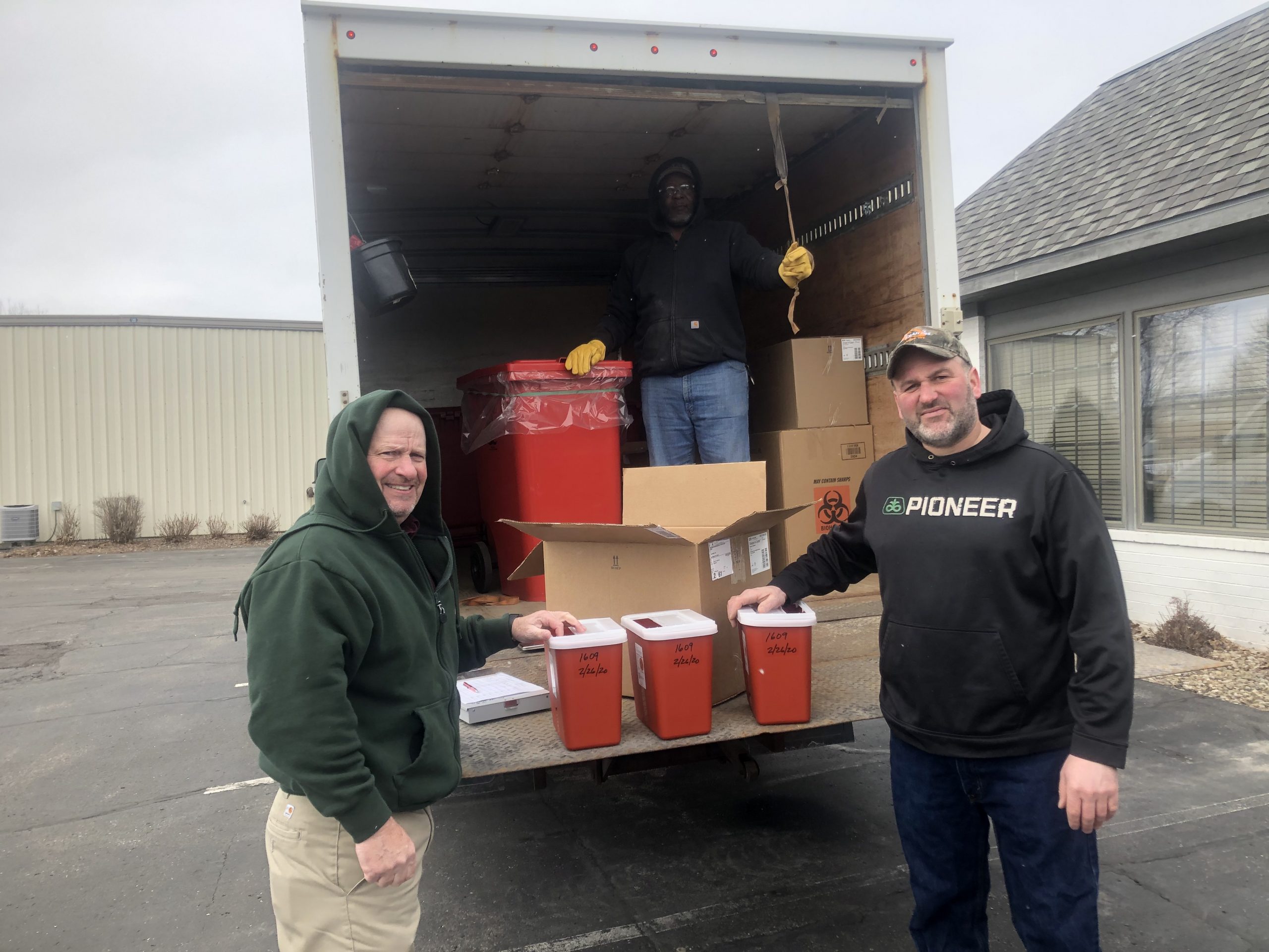 Grande Sharps Collection Top: MERI's Tyrone McGee is on hand as Grande's Randy Hardyman (left) hands producer Hardy Ripp a biohazard container as part of the sharps collection event held recently in Waunakee