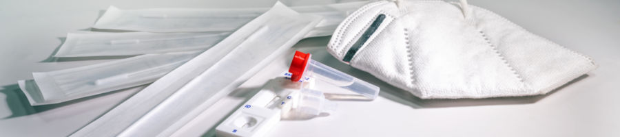 Testing Swab Covid-19 rapid antigen test and a mask on a light gray background