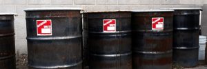 Black hazardous waste barrells