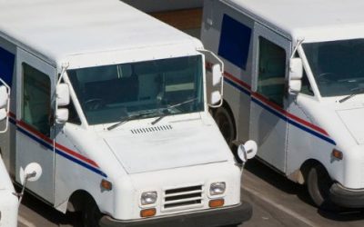 Row of U.S. postal mail delivery trucks